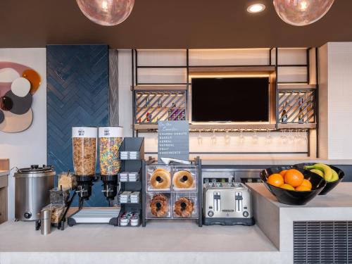 a bakery with donuts and other items on a counter at Atwell Suites Austin Airport by IHG in Austin