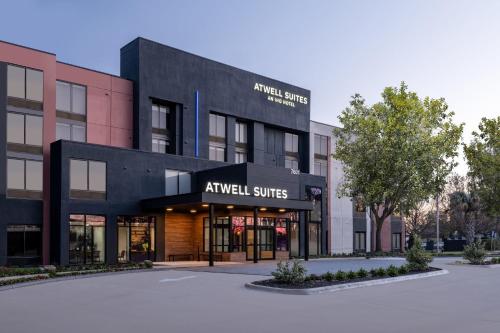 an empty parking lot in front of the arrival services building at Atwell Suites Austin Airport by IHG in Austin