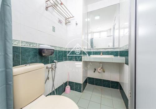 a bathroom with a tub and a toilet and a sink at (10Pax) 3BR Glory Beach Resort Seaview in Port Dickson