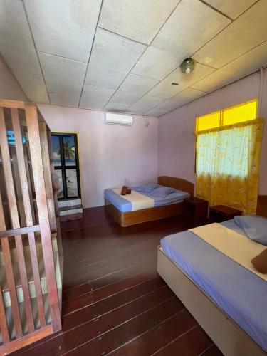刁曼島的住宿－SALANG SAYANG RESORT , PULAU TIOMAN，客房设有两张床和窗户。