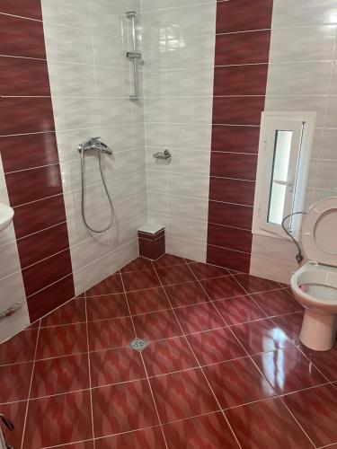 a bathroom with a shower and a toilet at Стаи за гости Първи май in Gabrovo