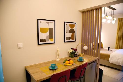 a room with a table with a bowl of fruit on it at Suites Rania in Áyios Yeóryios