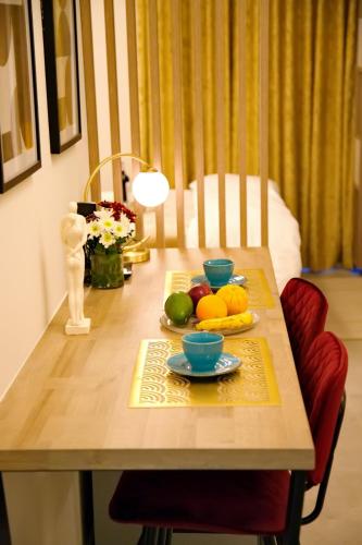 a wooden table with a plate of fruit on it at Suites Rania in Áyios Yeóryios