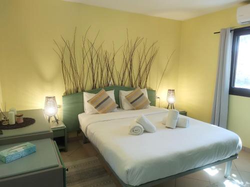 sypialnia z 2 łóżkami i 2 stołami z lampkami w obiekcie Summer Dream Cottage, 2BR, Beautiful sea view w mieście Mochlos