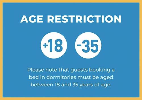 a sign that says age restriction and a bed in donutions must be aged between at Backpacker Naples in Naples