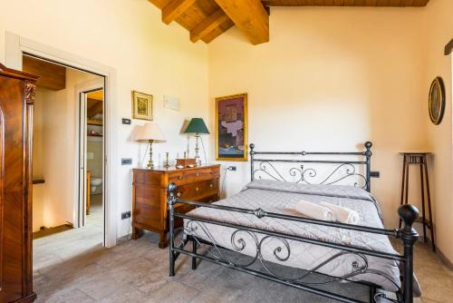 a bedroom with a bed and a dresser and a mirror at Fanano - Panoramic Villa by Alterego in Fanano