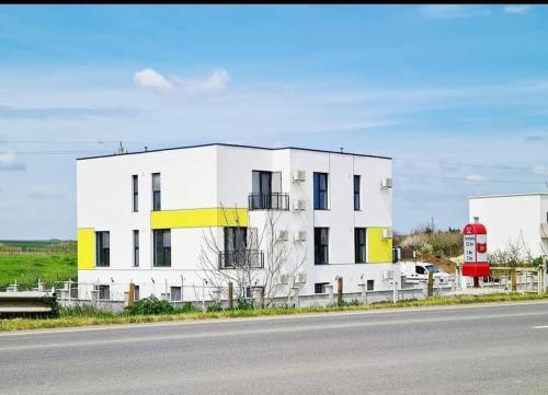 a white building on the side of a road at Studio Selena Vamaland in Vama Veche