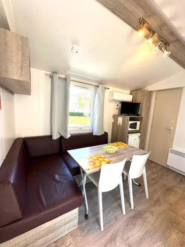 a small kitchen with a table and chairs in a caravan at Cottage 1 in Agarn