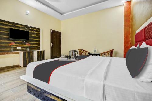 a hotel room with a large bed and a television at OYO Hotel The Bliss in Chandīgarh