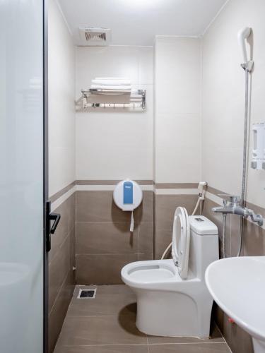 a bathroom with a toilet and a sink at Phuong Nam Luxury Hotel Long Bien in Hanoi