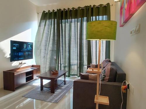 a living room with a couch and a table at No Fixed Address in Marmagao
