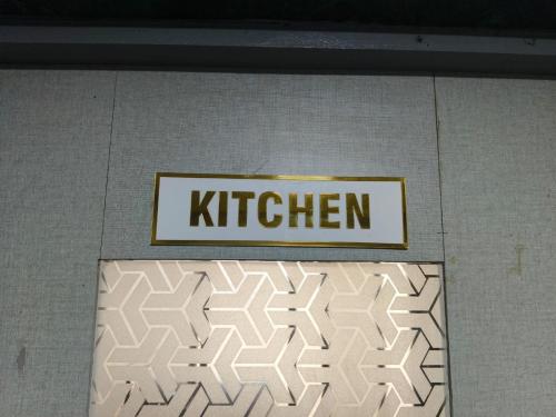 a sign that says kitchen on top of a wall at Rest Inn Hostel Dormitory in Mumbai