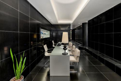 a conference room with chairs and a table with a lamp at Royal Beach Eilat by Isrotel Exclusive in Eilat