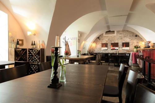 a dining room with a table and some chairs at Bioweingut Hauerhof 99 -apartment 1 in Klosterneuburg