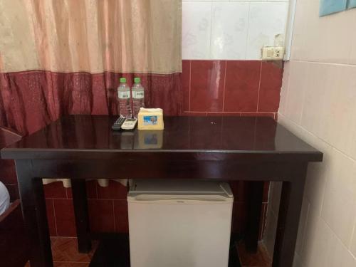 a table in a bathroom with two bottles on it at Ditar Guest House D in Battambang