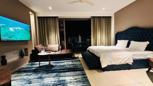 a hotel room with a bed and a tv at Luxury Studios Key 10 in Gurgaon