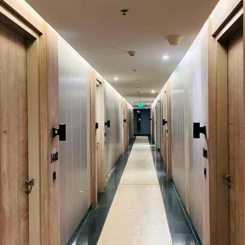 a hallway with wooden doors and a long aisle at Luxury Studios Key 10 in Gurgaon