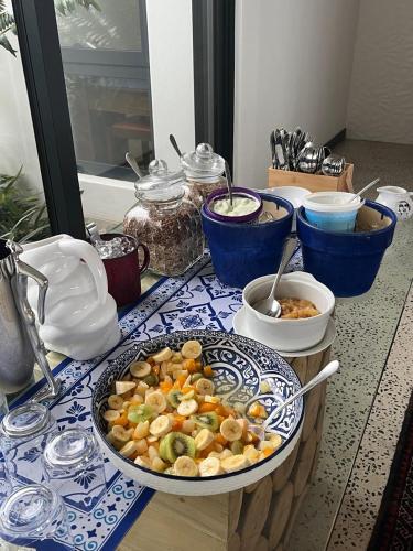 a table with a bowl of food on a table at Boutique Ocean Views - incorporating Wendy's in Hermanus