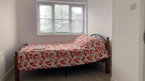 a small bed in a room with a window at Beautiful Bedroom near Barking Railway station in london with good Transport Link direct connect with central london in Barking