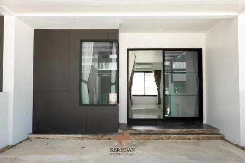 a building with a glass door in a building at Malada in Chiang Mai