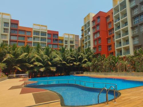 a swimming pool in front of some apartment buildings at No Fixed Address in Marmagao