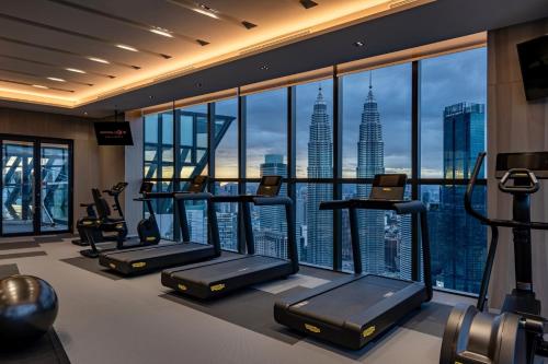 a gym with a view of the empire state building at Imperial Lexis Kuala Lumpur in Kuala Lumpur