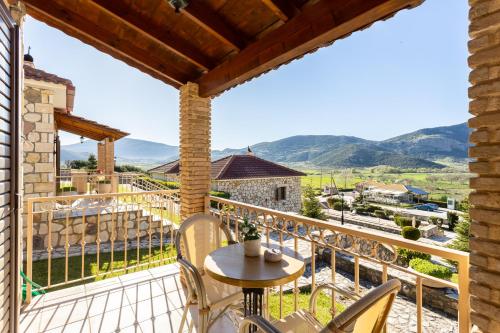 a view from the balcony of a house with a table and chairs at Pleiades All Season Gems - Korinthos Stone Retreats in Kalianoi