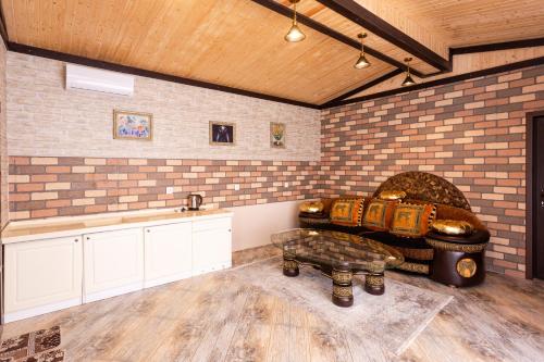 a living room with a couch and a table at Aynur Qala Resort in Quba
