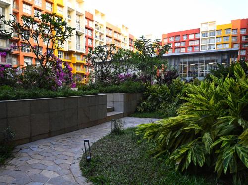 a garden in front of a large apartment building at No Fixed Address in Marmagao