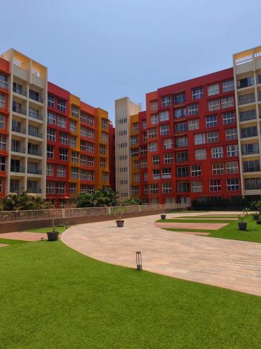 a park in front of some tall buildings at No Fixed Address in Marmagao