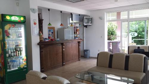 a waiting room with a refrigerator and a bar at Hotel Diva in Ravda