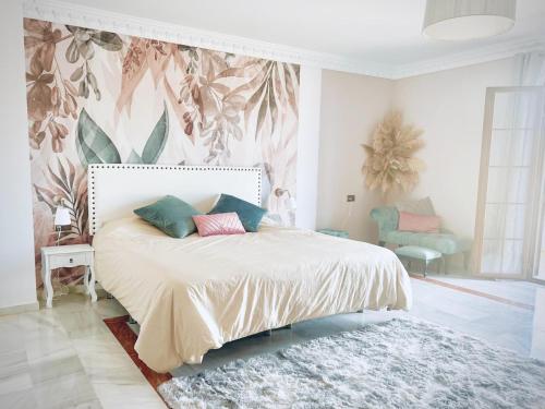 a bedroom with a bed with a white bedspread at The Castle on the Hill! in Málaga