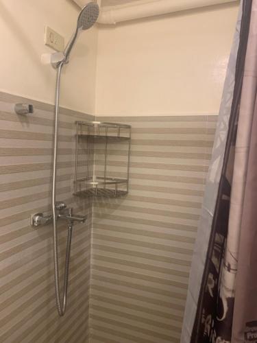 a shower with a shower head in a bathroom at TraveLodge in Cainta