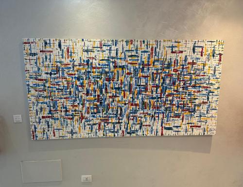 a painting is hanging on a wall at Hotel Mediterraneo in Roccella Ionica