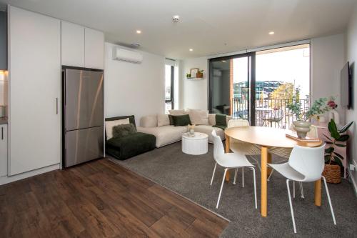 a living room with a table and a couch at The Mixer - 2 Bed Central City in Christchurch