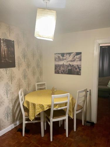 a dining room with a yellow table and chairs at Heart of West London in London