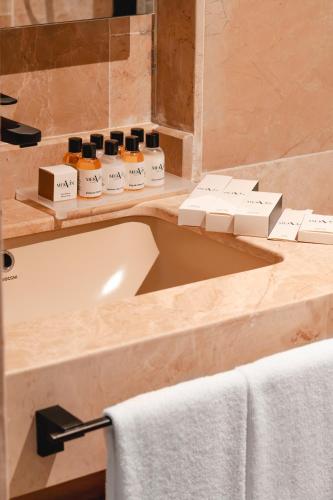 a bathroom with a sink and a bath tub at Novva Hotels Kas in Kaş