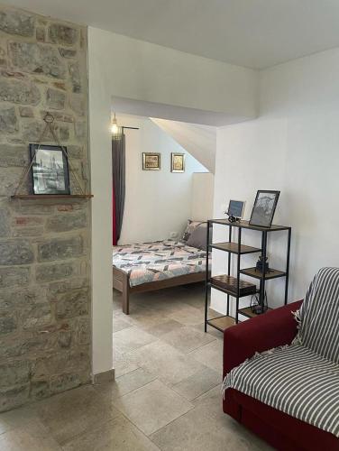 a living room with a bed and a couch at TRE SORELLE in Piran