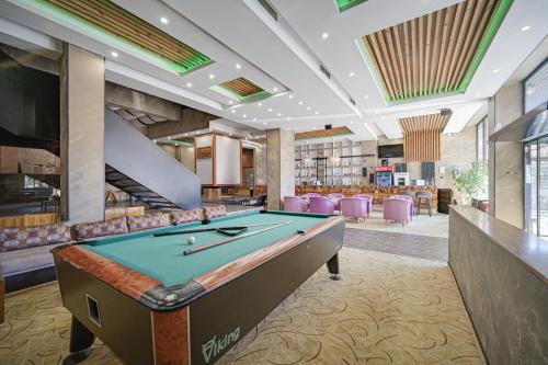 a billiard room with a pool table in a library at Riverside Boutique Hotel in Bansko