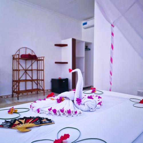 a white swan sitting on top of a table at TIANDE Boutique Hotel in Pwani Mchangani