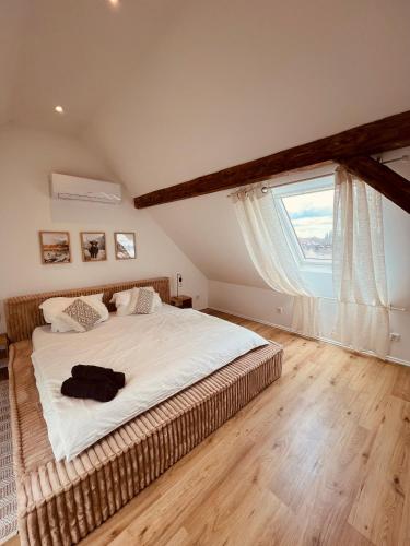 a bedroom with a large bed with a large window at Maisonette-Apartment mit Klimaanlage - in Dorsten Zentrum - in Dorsten