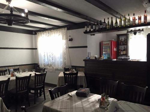 a dining room with tables and chairs in a restaurant at Family Hotel Ginger in Pamporovo