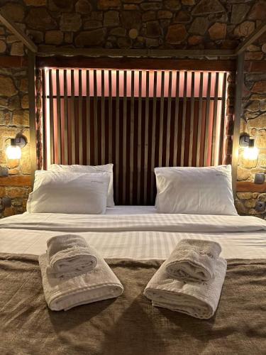 a bedroom with a large bed with towels on it at Ζέον Ύδωρ in Órma