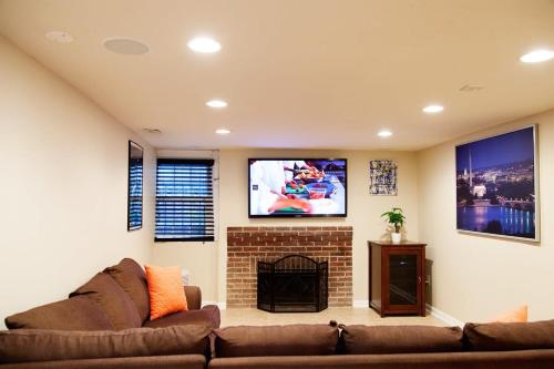 a living room with a couch and a tv at 1BR Oasis near Takoma Metro Minutes to Capital in Washington, D.C.