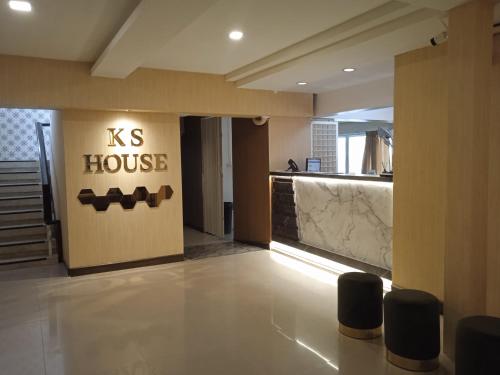 a kiss house sign on the wall of a lobby at KS HOUSE in Bangkok