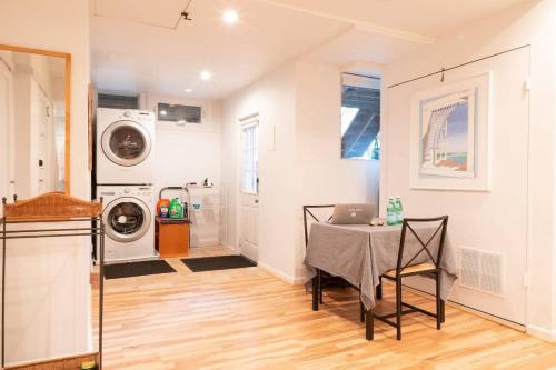 a laundry room with a table with a laptop on it at Huge Studio w Full Kitchen W D Parking in Washington, D.C.