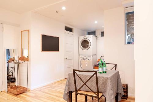 a laundry room with a table and a washing machine at Huge Studio w Full Kitchen W D Parking in Washington, D.C.