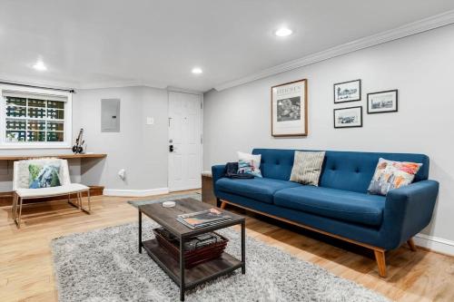 a living room with a blue couch and a table at Entire 1-BR Apt in NoMa Eckington in Washington, D.C.