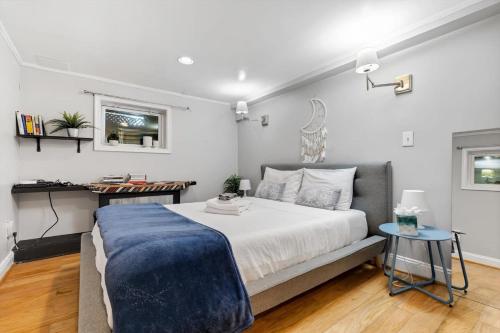 a bedroom with a large bed with a blue blanket on it at Entire 1-BR Apt in NoMa Eckington in Washington, D.C.