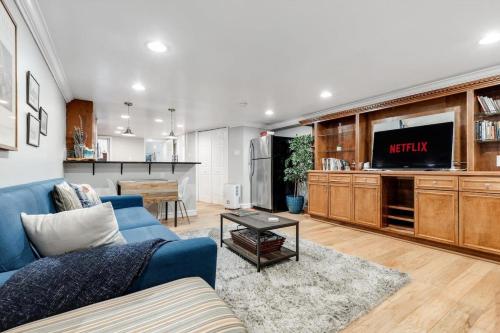 a living room with a blue couch and a tv at Entire 1-BR Apt in NoMa Eckington in Washington, D.C.